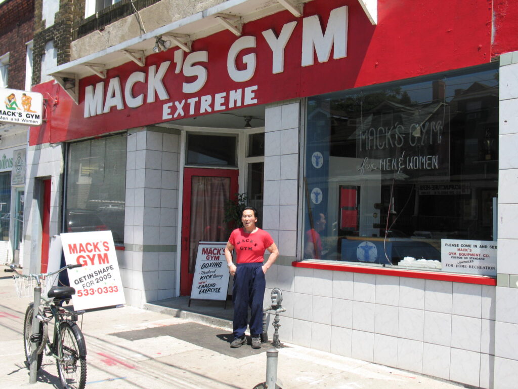 Canadian Fitness Legend Mack Miya standing in front of Mack's Gym