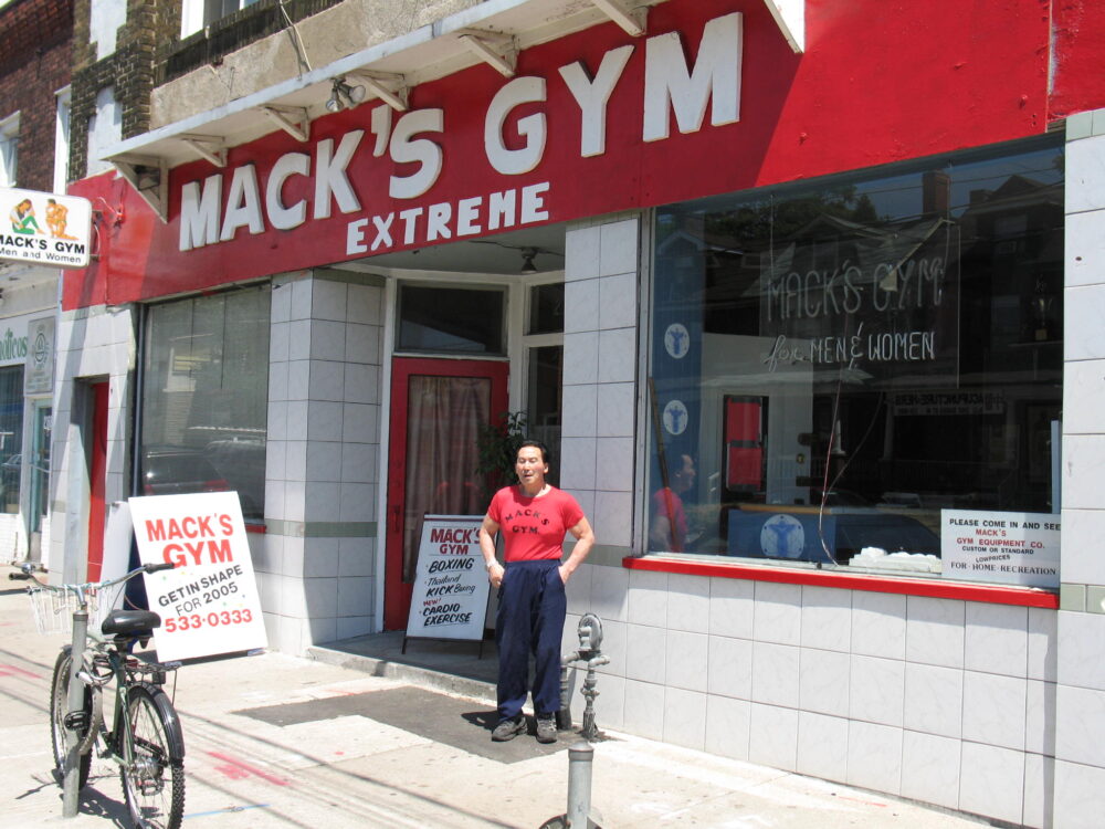 Canadian Fitness Legend Mack Miya in front of Mack's Gym